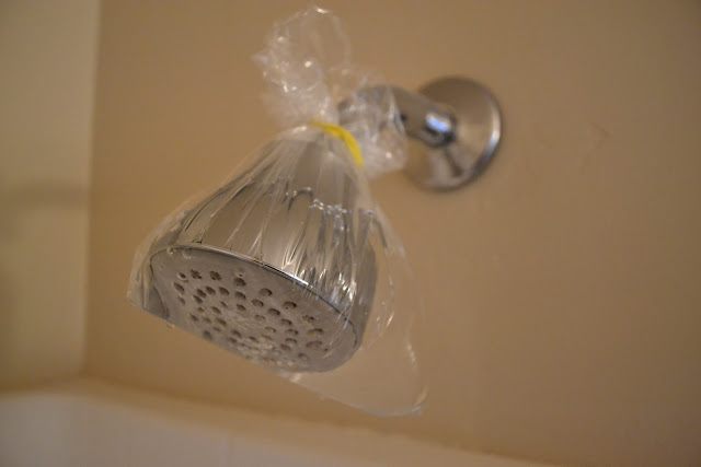wiping down clogged shower heads ways you're getting house cleaning wrong
