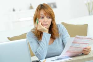 Woman looks worried about home insurance bill