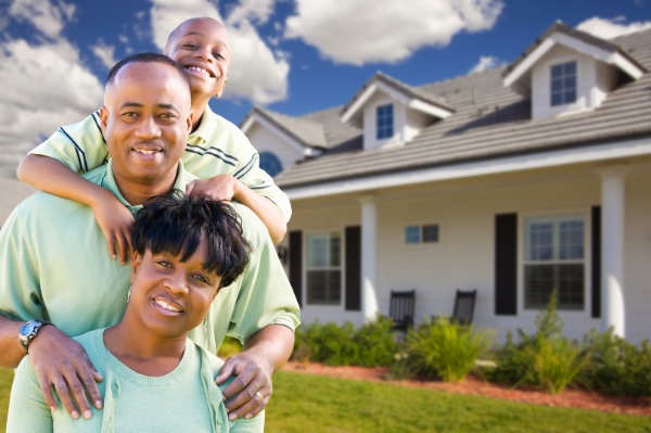 Family in front of their new house after buying a home warranty