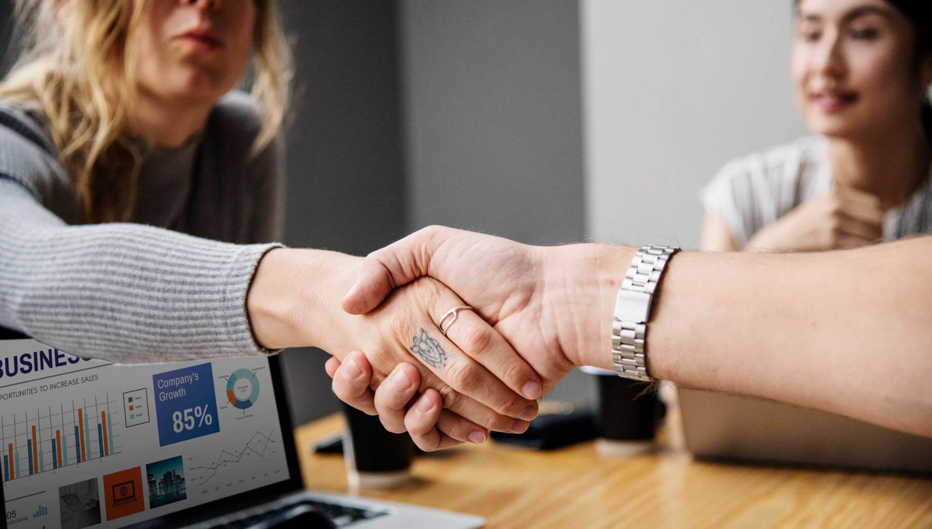 woman shaking hands over loan transaction