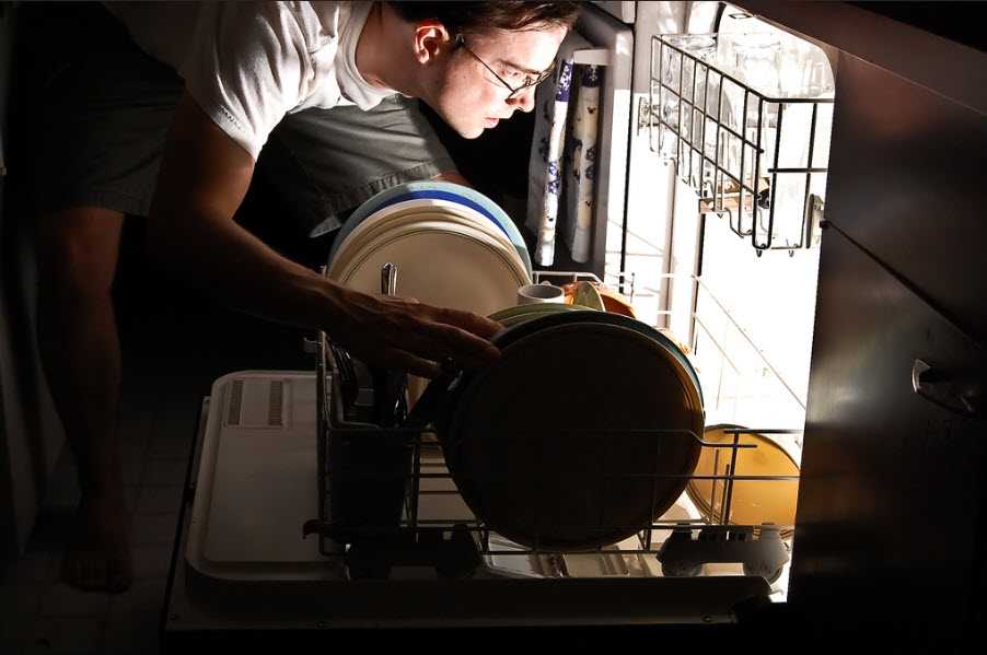 man loading dishwasher