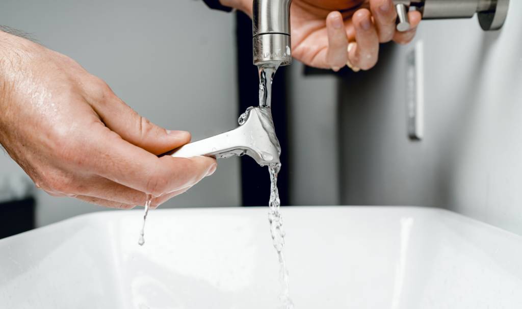 Man checking his plumbing system for leaks